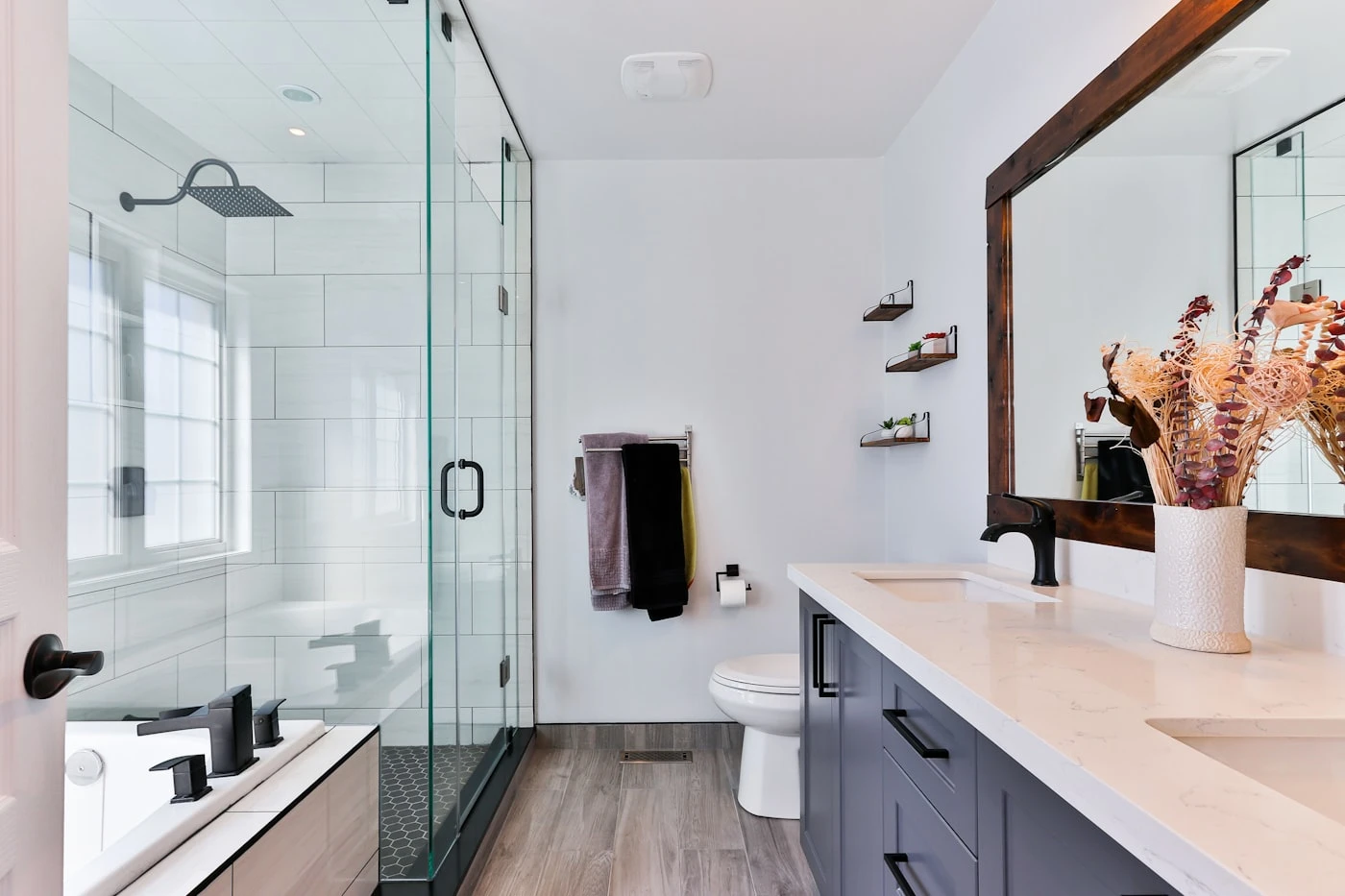 Modern bathroom remodel with glass shower enclosure and matte black fixtures